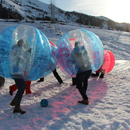 Partie de football en bulles gonflables dans la neige